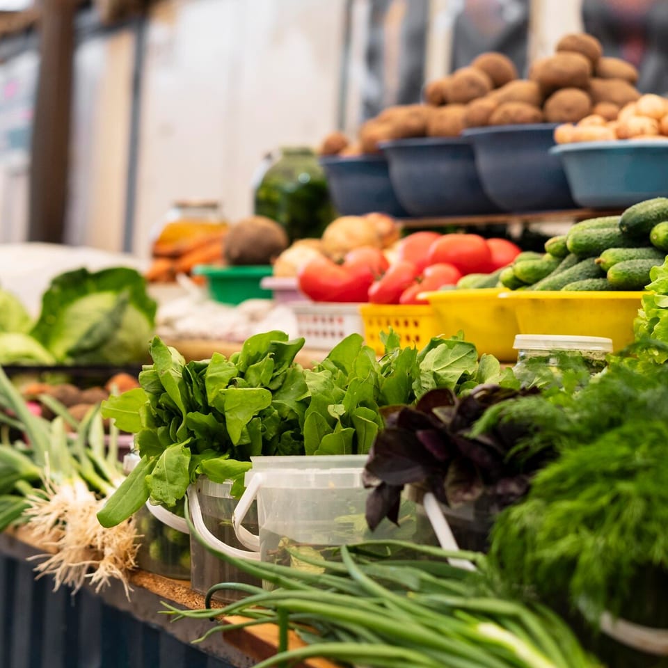 Puesto de mercado de proximidad con frutas y verduras frescas